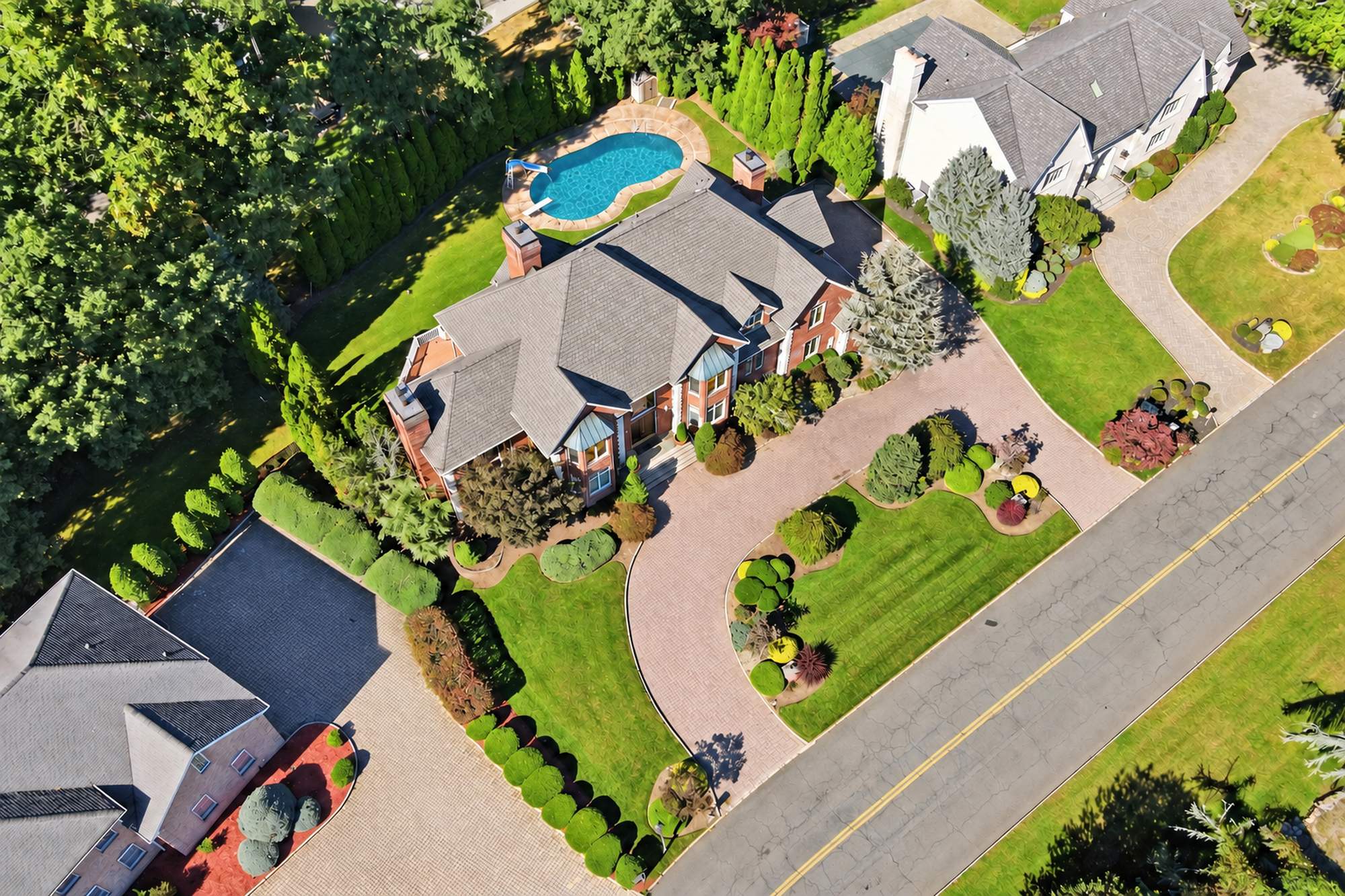 Aerial view of the house, driveway, and pool at 54 Burnet Hill Road, Livingston