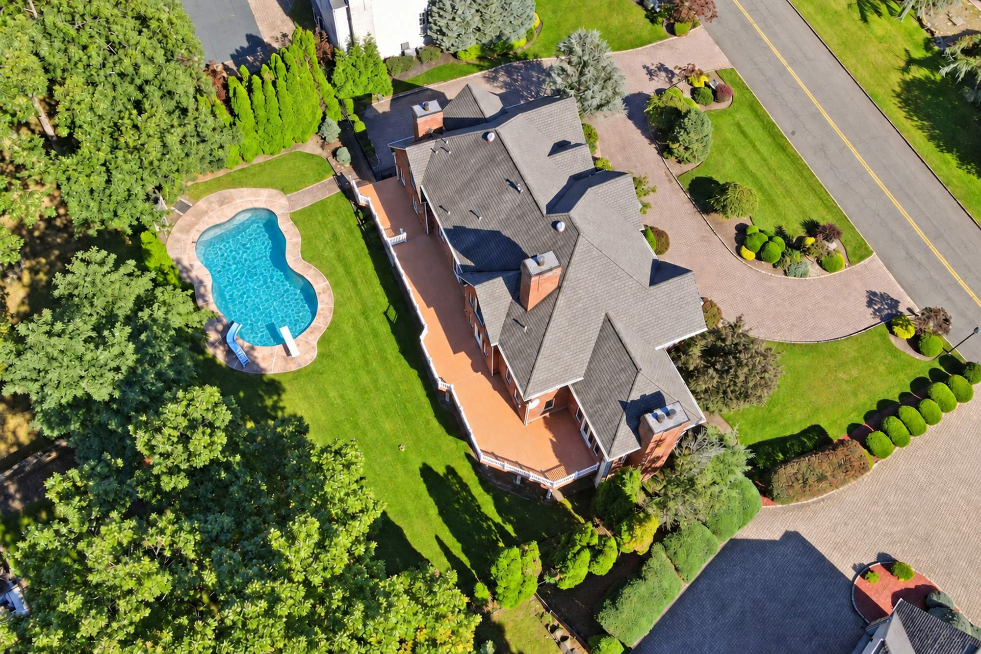 Aerial view of the deck, pool, and yard at 54 Burnet Hill Road, Livingston