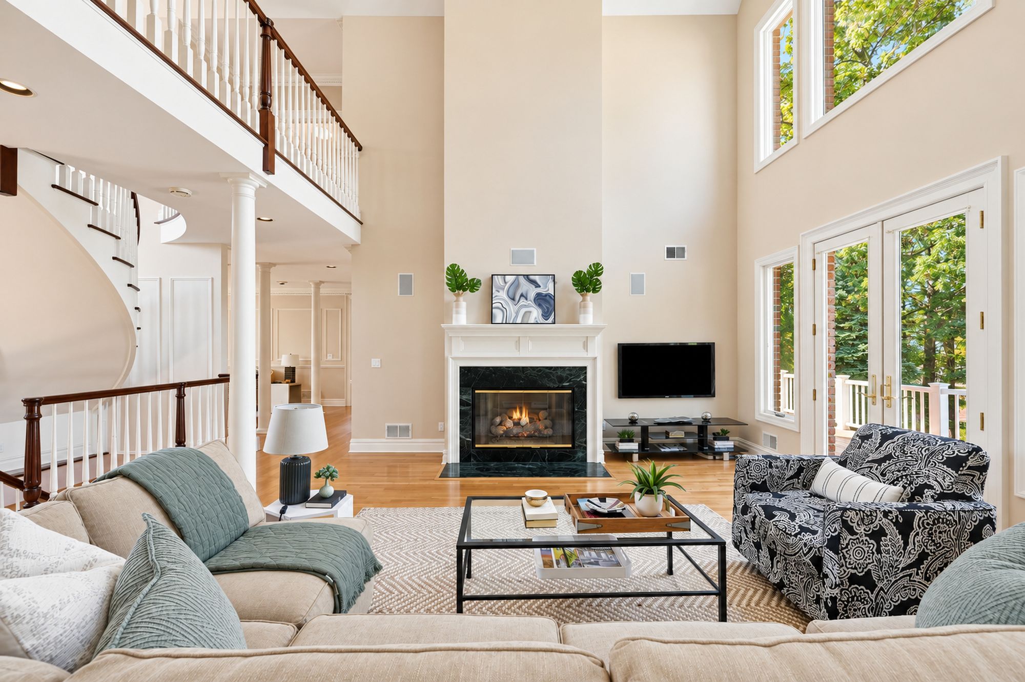Two-story great room with fireplace and tall windows at 54 Burnet Hill Road, Livingston