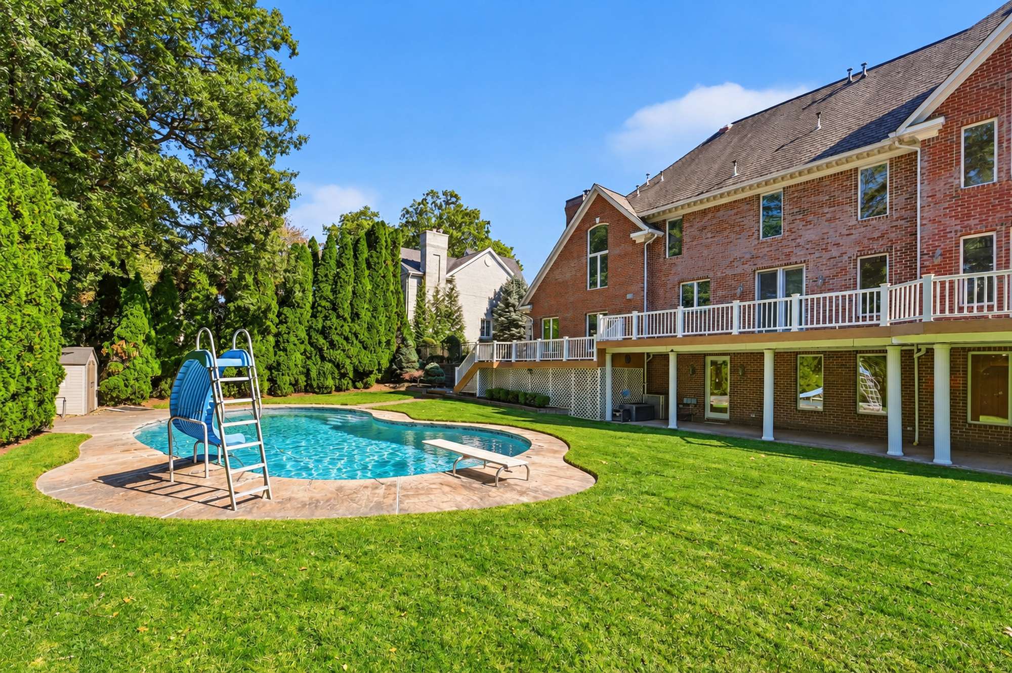 Heated pool with the house beyond at 54 Burnet Hill Road, Livingston